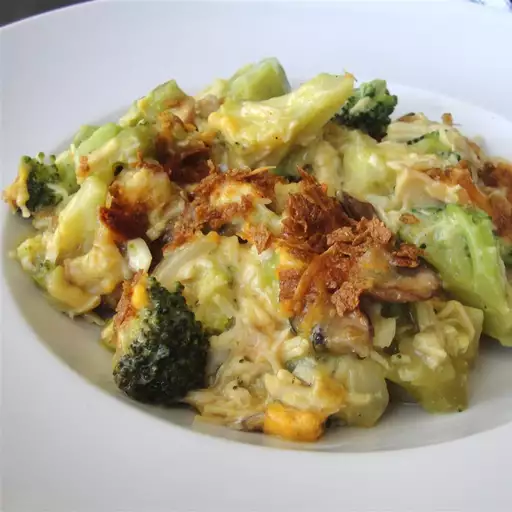 Curried chicken and broccoli casserole served in a white bowl