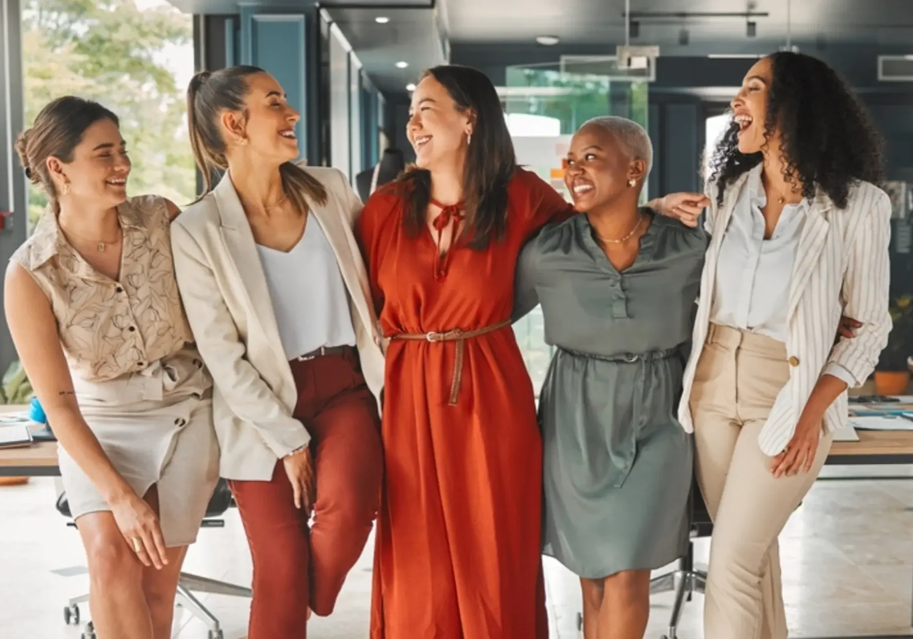 Diverse group of 5 women community coordinators joined arm and arm